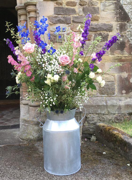 Milk churn with a mix of country flowers